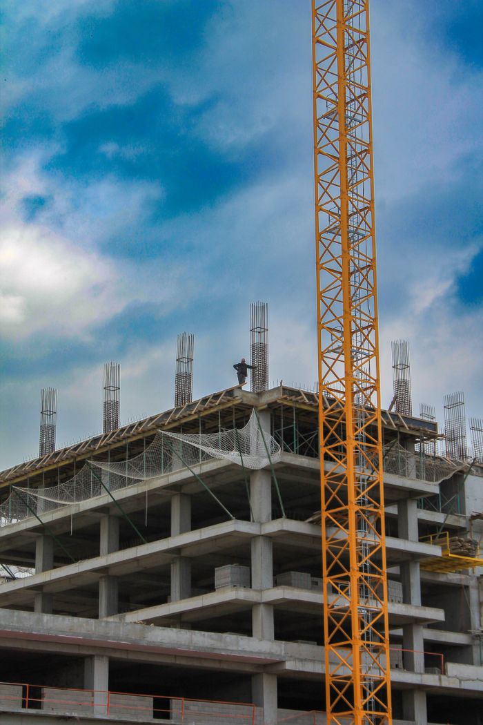 Construction site with crane and building in Bursa, Türkiye under clear sky.